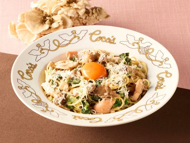 卵黄がトッピングされたトリュフ香るサーモンときのこのクリームパスタ