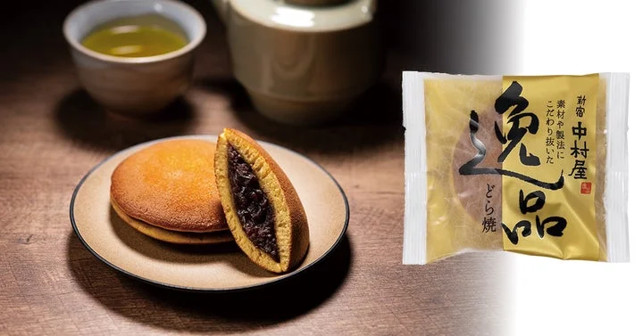 逸品どら焼の断面とパッケージ。湯呑みと急須が背景に写っている。
