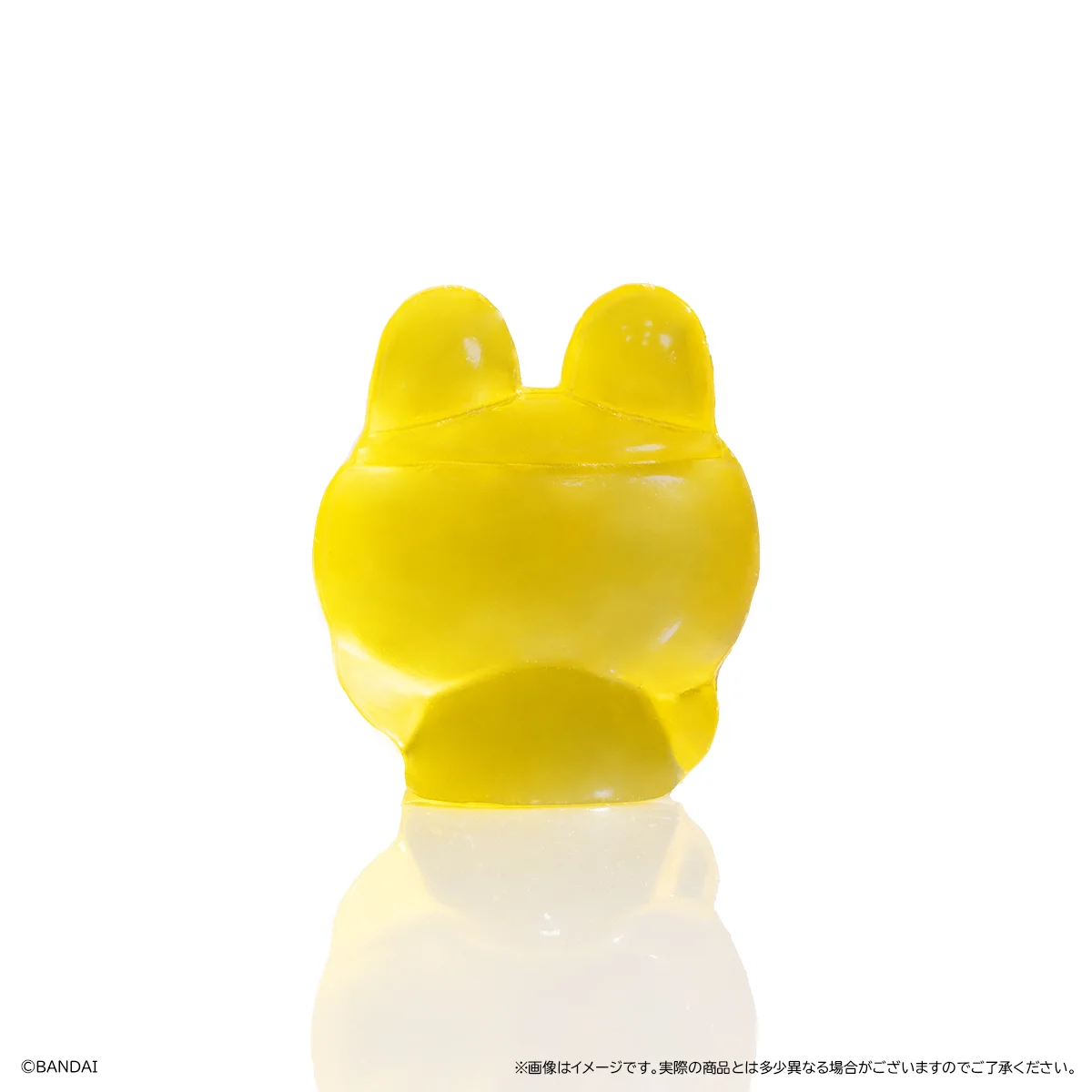 4Dグミ/たまごっち まめっちグミの背面。黄色い半透明の立体グミで、上部に耳のような突起がある。