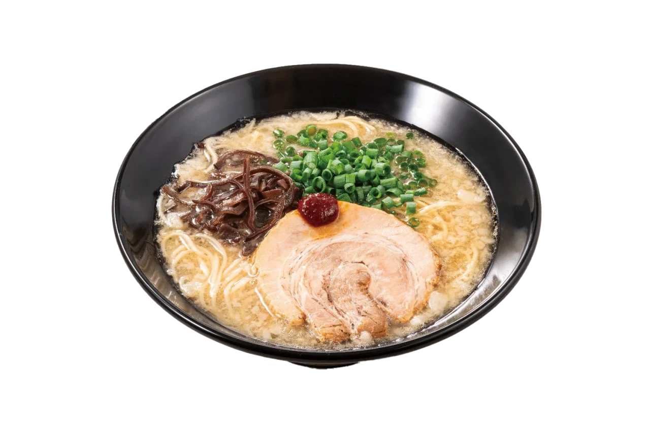黒い丼に盛られた豚骨ラーメン。細麺にチャーシュー、ネギ、もやし、赤い辛味調味料が添えられている。
