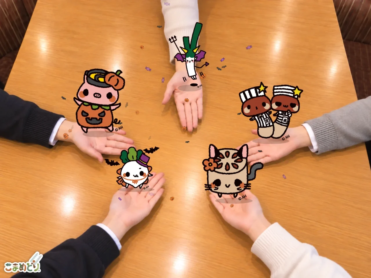 しゃぶ葉フレンズとハロウィンARカメラで、手のひらに仮装キャラクターを映した様子