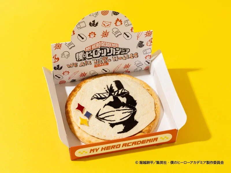 【オールマイト】マルゲリータ。顔の絵柄が載った丸いピザを開いた箱に収めた様子