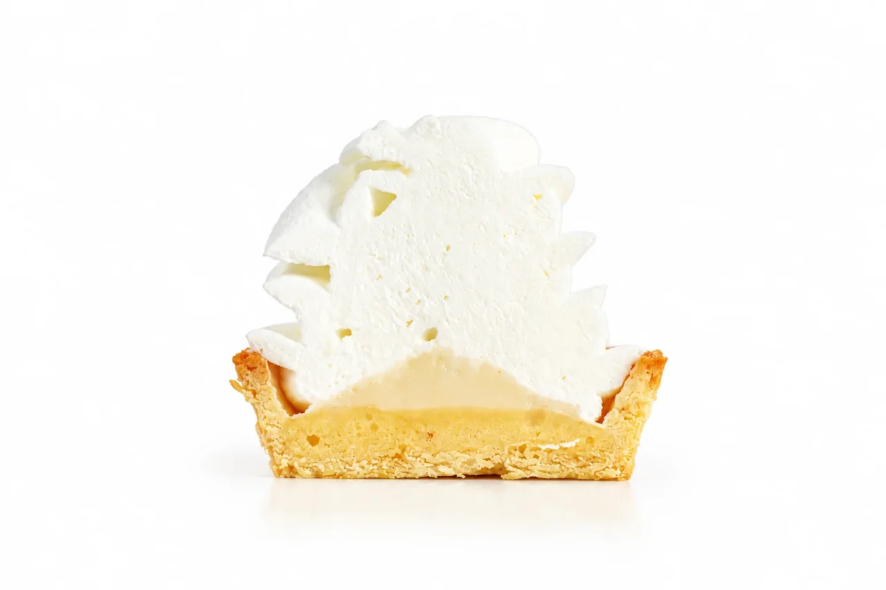 ミルキーモンブランタルトの断面。厚い白いクリームと淡黄色のソース層