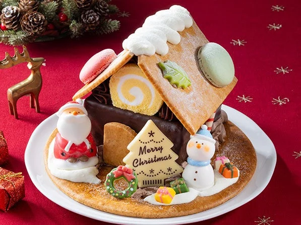 Xmasサンタさんのお菓子の家。サンタやスノーマンの飾りが載ったお菓子の家