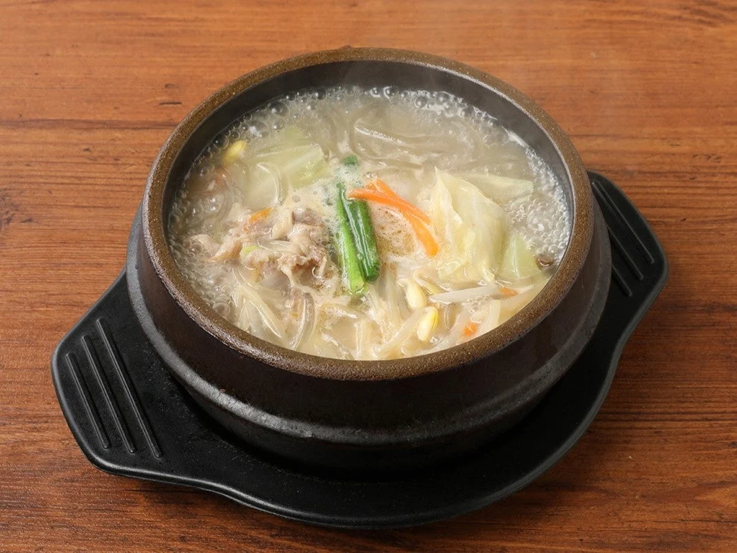 黒い石鍋に入ったソルロンタンチゲ。白濁スープに野菜と肉