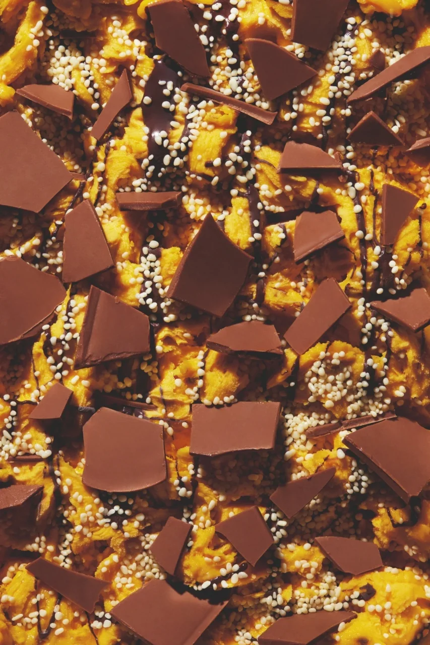 ジェラート「チョコビア マンゴー」のアップ。板チョコ片と白い粒が散る