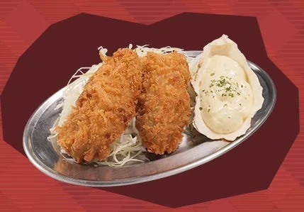 特大 牡蠣フライ(2個)。キャベツを敷いた皿に盛られた衣の揚げ物