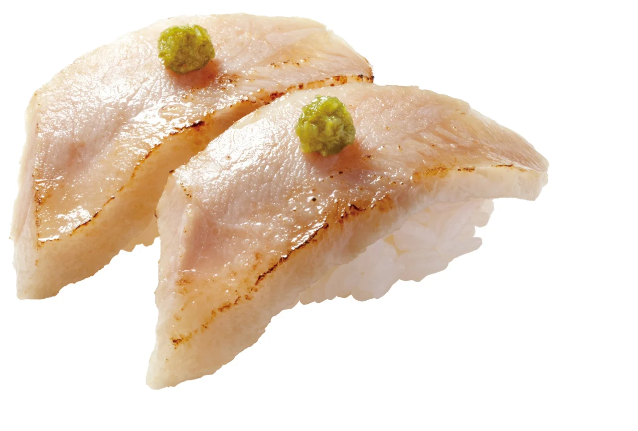 炙り豚(とん)とろ(柚子胡椒のせ)の握り2貫。焦げ目のある肉に緑のペースト