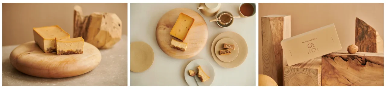 Mr. CHEESECAKE クルミッ子のチーズケーキと限定ボックスを木の皿や木材と並べた様子