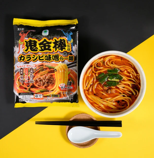 鬼金棒監修カラシビ味噌らー麺のパッケージと、器に入った赤いスープの麺