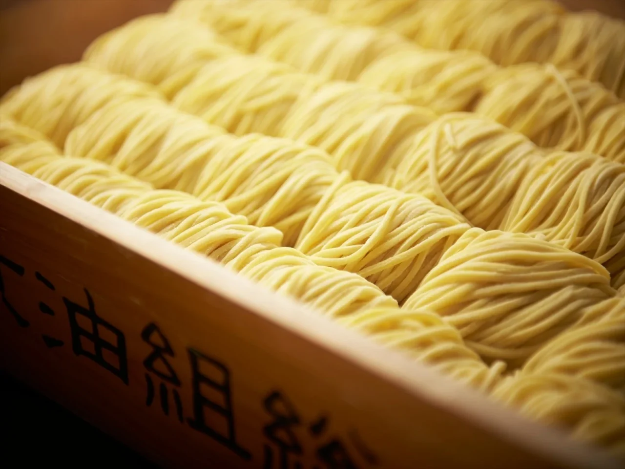 老舗製麺所と共同開発した自家製麺が木箱に並ぶ様子